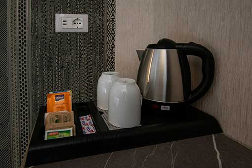 Electric kettle with tea bags (tea, chamomile) and coffee